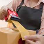 Portrait of starting a small business SME business owner Female entrepreneur working on merchandise boxes Receipts and checks online orders to prepare boxes for seller to customers.